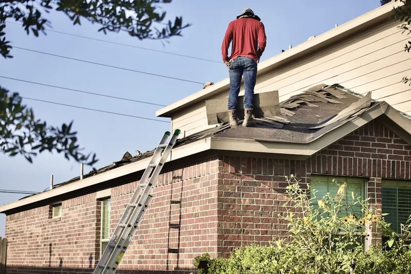 Professional roofer working on a residential roof in Jamestown Court